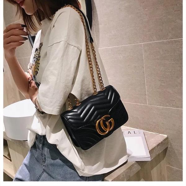 pink quilted shoulder crossbody bag with a gold tone chain strap and gold tone double G style hardware