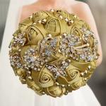 beautiful gold/olive satin rose bouquet with rhinestone butterflies and floral jewelry accents.