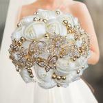beautiful gold/olive satin rose bouquet with rhinestone butterflies and floral jewelry accents.